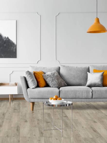 Real photo of a modern living room interior with a sofa, orange lamps and painting